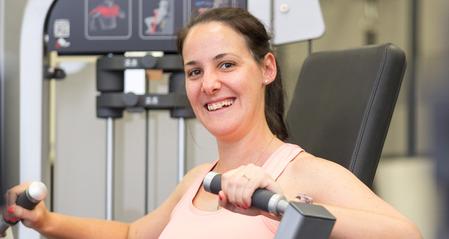 Adult using gym equipment at Genesis Fitness Centre